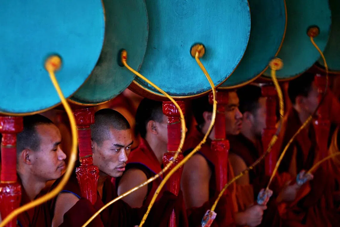 Buddhist monks playing drums during morning prayers at Gyuto Monastery in Dharamsala, India on Oct 11.