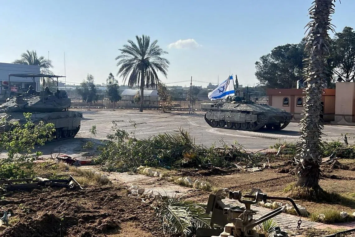 FILE PHOTO: Israeli military vehicles operate in the Gazan side of the Rafah Crossing, amid the ongoing conflict between Israel and Palestinian Islamist group Hamas, in the southern Gaza Strip, in this handout image released on May 7, 2024. Israel Defense Forces/Handout via REUTERS/File Photo