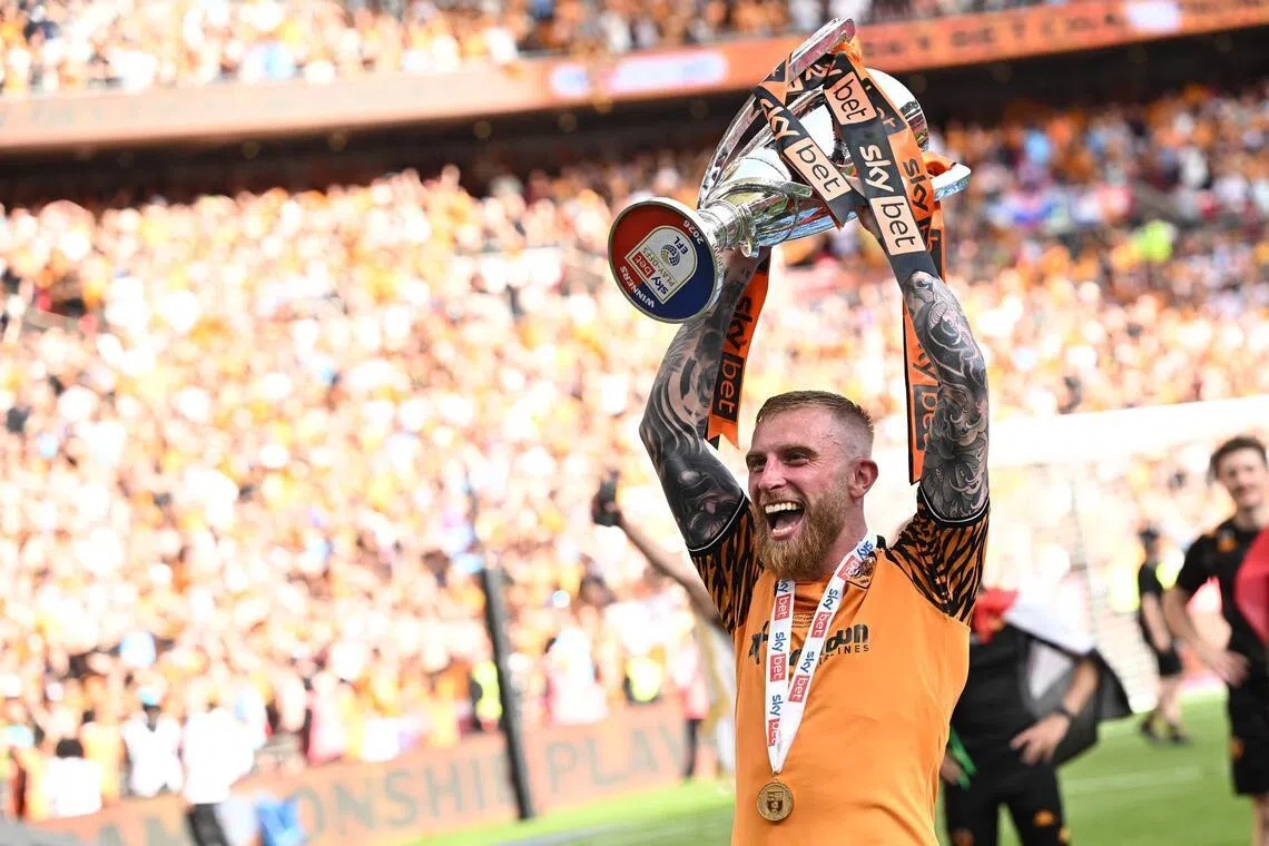 Hull City's Oli McBurnie - who scored the only goal of the match - celebrating with the trophy on May 23, after his team won promotion to the Premier League over Championship rivals Middlesbrough.