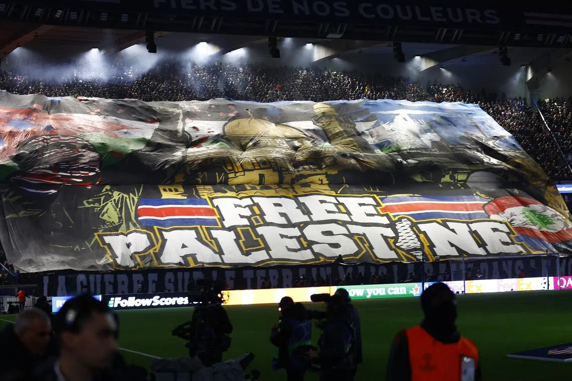 Soccer Football - Champions League - Paris St Germain v Atletico Madrid - Parc des Princes, Paris, France - November 6, 2024 A banner on support of Palestine is displayed in the stands before the match REUTERS/Stephanie Lecocq