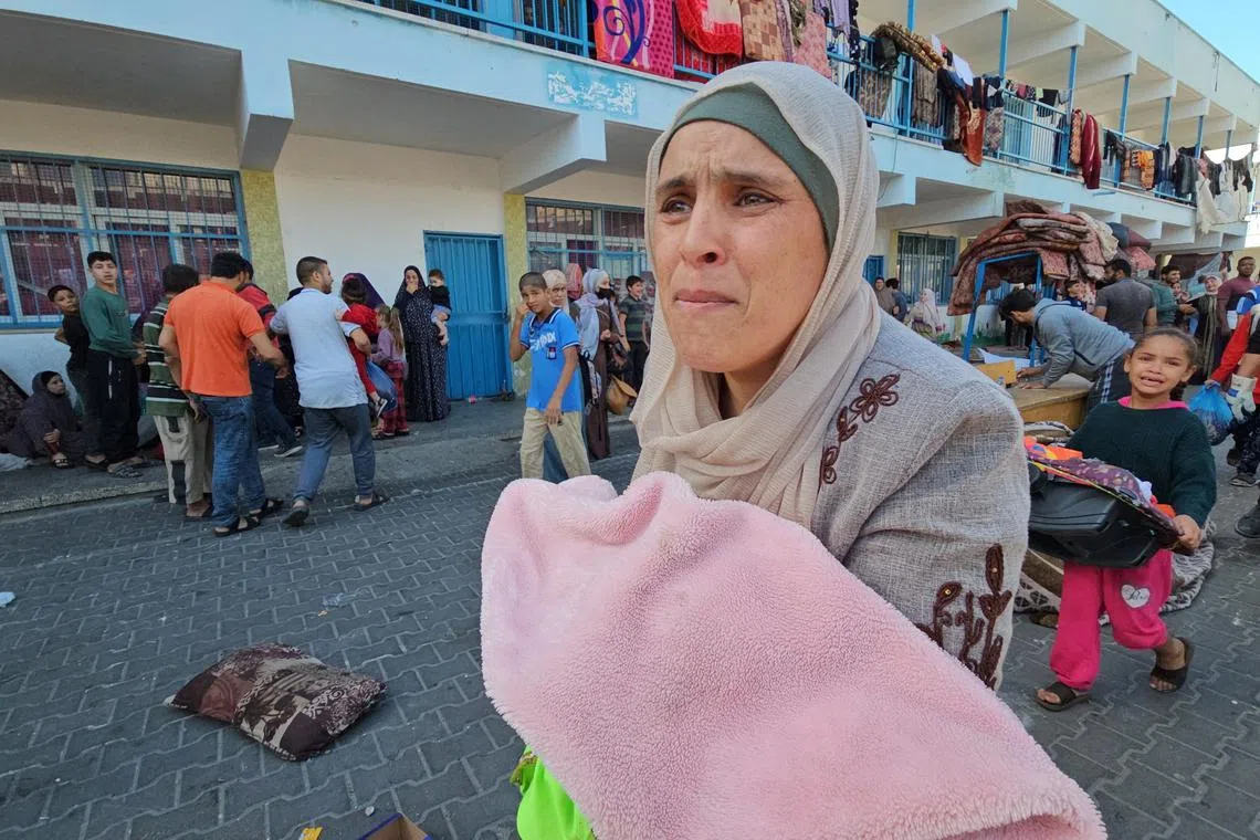 Palestinians crying after a strike at a UN-run school sheltering displaced people in Jabalia refugee camp on Nov 4.