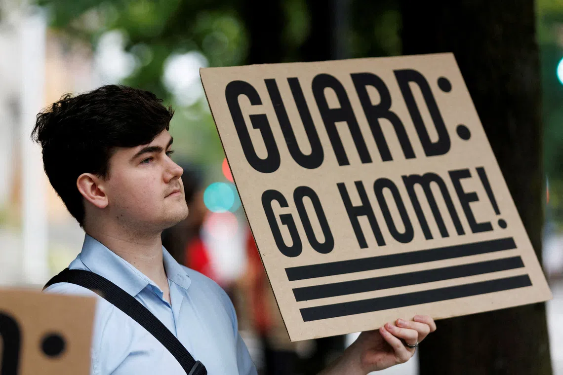 A protester holds a sign at a rally at Mark O. Hatfield Federal Courthouse in Portland, on Oct 3.