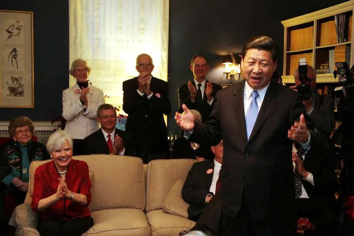 FILE PHOTO: China's Vice President Xi Jinping speaks at the home of Roger and Sarah Lande (2nd L) in Muscatine, Iowa February 15, 2012. Xi joked about receiving a gift of popcorn during his first visit to Muscatine in 1985.  REUTERS/Kevin E. Schmidt/Pool /File Photo