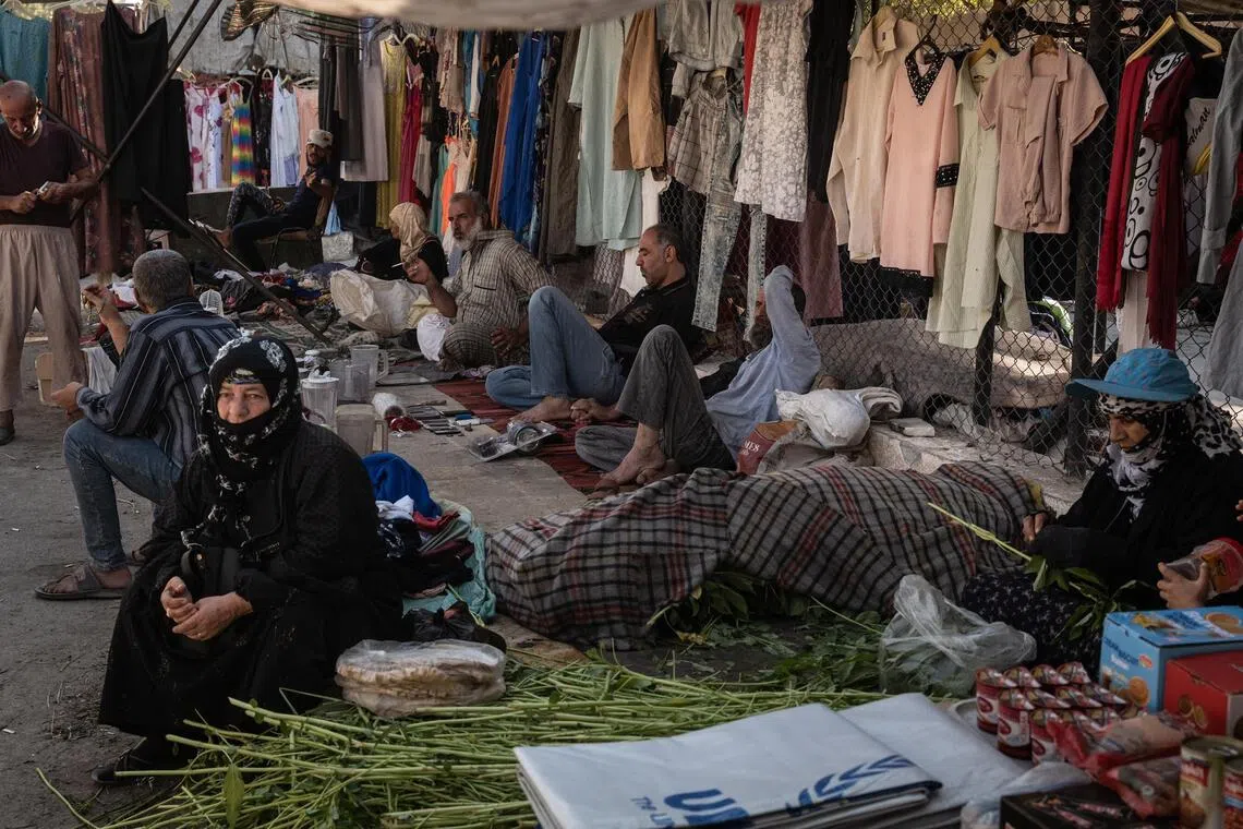 Vendors selling clothes and food at a market in Deir al-Zour, which was the most heavily damaged city during Syria’s 13-year civil war.