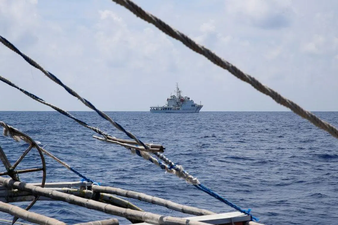 FILE PHOTO: A China Coast Guard ship is seen from a Philippine fishing boat at the disputed Scarborough Shoal April 6, 2017. Picture taken April 6, 2017.    REUTERS/Erik De Castro/ File photo