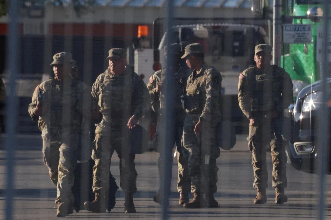 FILE PHOTO: National Guard members walk at the U.S. Immigration and Customs Enforcement (ICE) Broadview facility in Chicago, Illinois, U.S., October 9, 2025. REUTERS/Jeenah Moon/File Photo