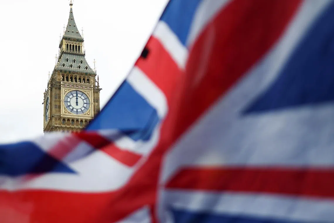 FILE PHOTO: The Union Jack flag is flown outside the Houses of Parliament, in London, Britain February 9, 2022. REUTERS/Tom Nicholson/File Photo