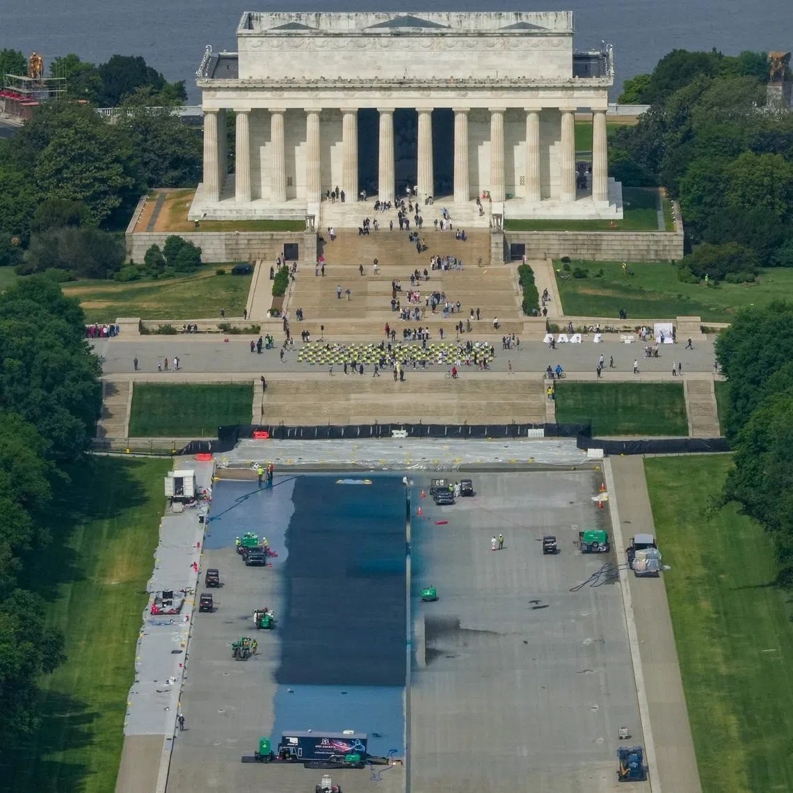 Workers continue renovations on the Lincoln Memorial Reflecting Pool, which is being painted blue, in Washington DC, on May 2.