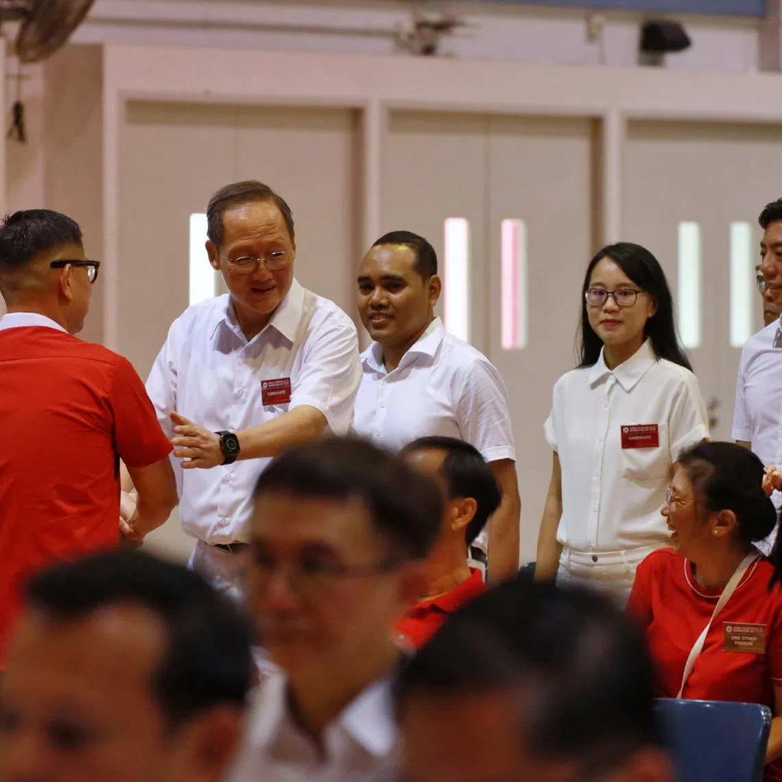 PAP CCK GRC candidates Tan See Leng, Zhulkarnain Abdul Rahim, Choo Pei Ling, Jeffrey Siow meeting PSP candidate Lawrence Pek in the hall at Jurong-Pioneer Junior College nomination centre on April 23.