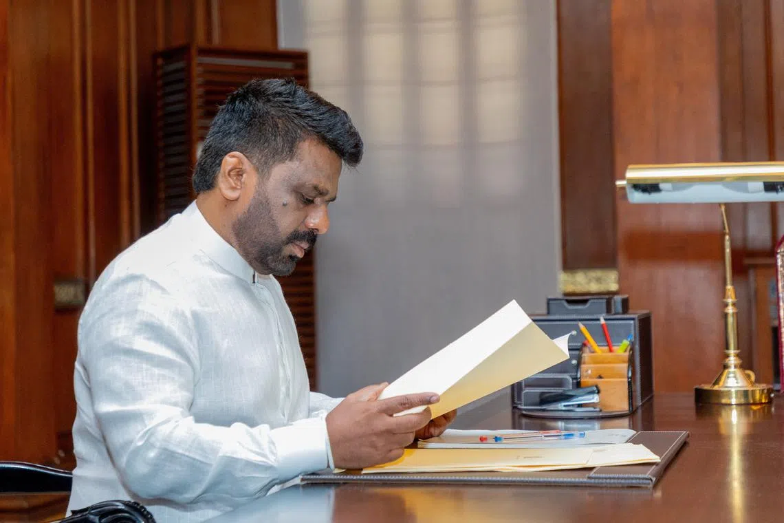 FILE PHOTO: Sri Lanka's newly elected President Anura Kumara Dissanayake reads a document after being sworn in as president at the Presidential Secretariat, in Colombo, Sri Lanka, September 23, 2024. Sri Lanka President Media/Handout via REUTERS/File Photo