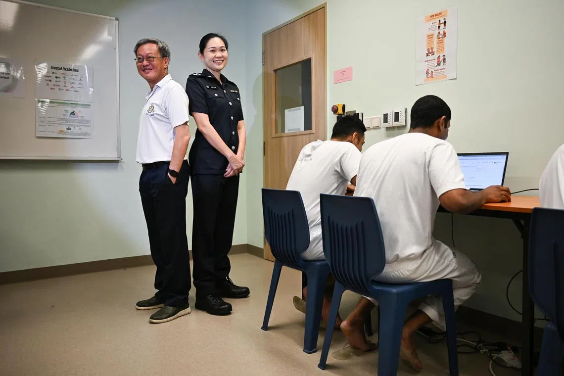ST20250109-202500600300-Lim Yaohui-Caelyn Tan-ctprison9/
Service Ambassador Andrew Cheang, (left, standing) 62, and Deputy Superintendent of Police (DSP) June Ngiam, (right, standing) 39, Staff Officer (Future Operations), Operations Division, next to inmates accessing government e-services with their SingPass account in the terminals at Institution S2 Resource Centre in Selarang Park Complex on Jan 9, 2025.
Since September 2024, Institution S2 Resource Centre has been pioneering a trial programme that allows inmates to independently utilise selected government e-services with their Singpass account. The programme, Access for Inmates Digital Experience (AIDE), is supported by a Service Ambassador (SA), who is available at the Resource Centre twice a week to assist with matters such as resetting Singpass passwords and guiding inmates on how to use the e-services.
(ST PHOTO: LIM YAOHUI)