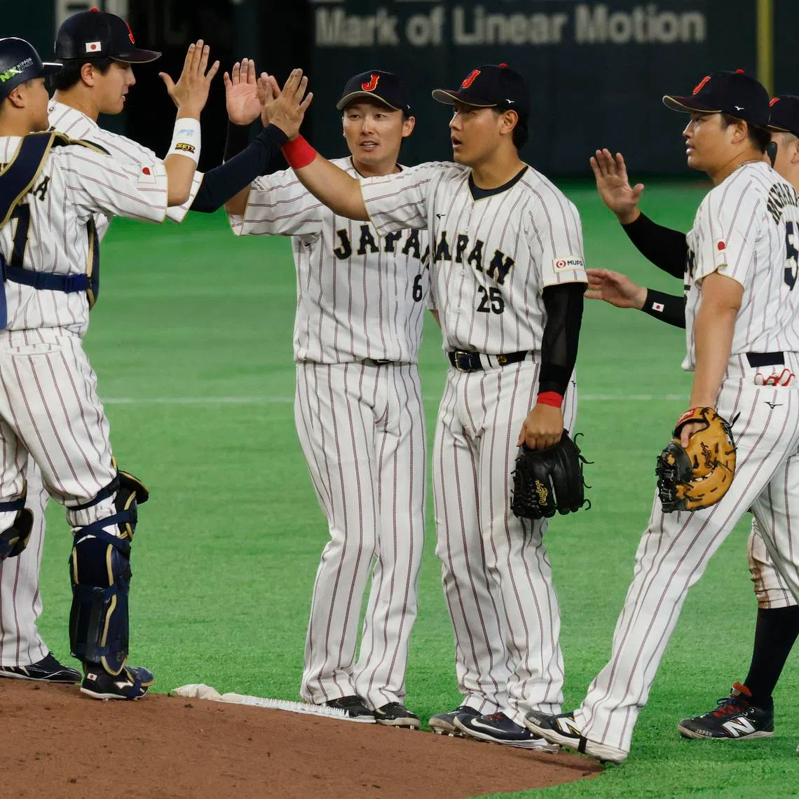 Baseball - World Baseball Classic - Pool C - Czech Republic v Japan - Tokyo Dome, Tokyo, Japan - March 10, 2026 Japan's Kazuma Okamoto and Japan's Sosuke Genda celebrate with teammates after the match REUTERS/Kim Kyung-Hoon