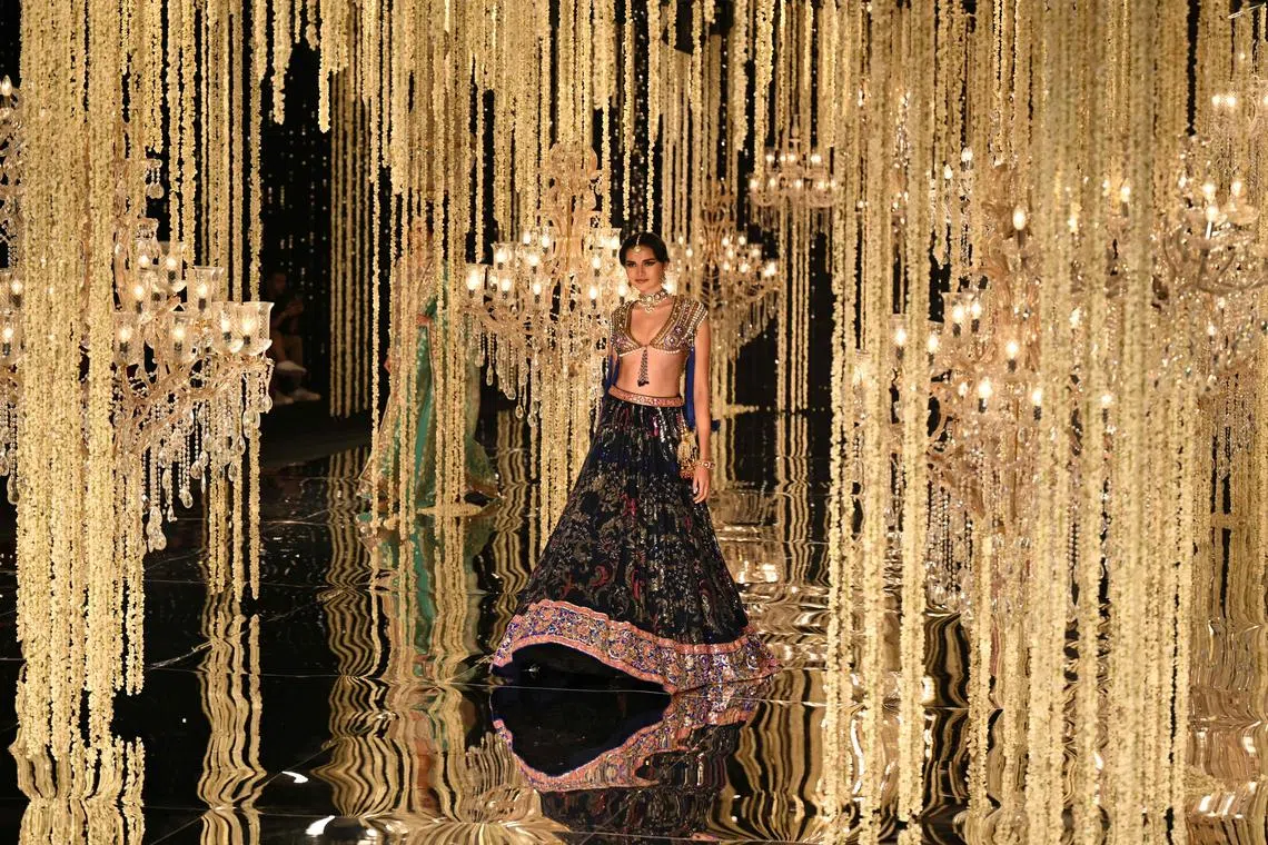 A model presenting a creation by designer Suneet Varma during the FDCI India Couture Week in New Delhi on July 26, 2023. 