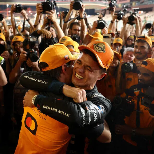 McLaren's Lando Norris celebrates with his teammate Oscar Piastri and the rest of his team after becoming the 2025 Formula One world champion.