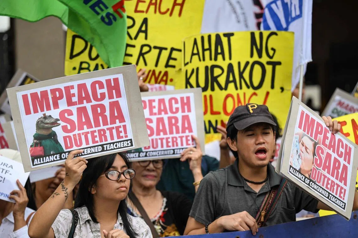 Protesters call for the impeachment of Philippine Vice-President Sara Duterte outside the House of Representatives in Manila.
