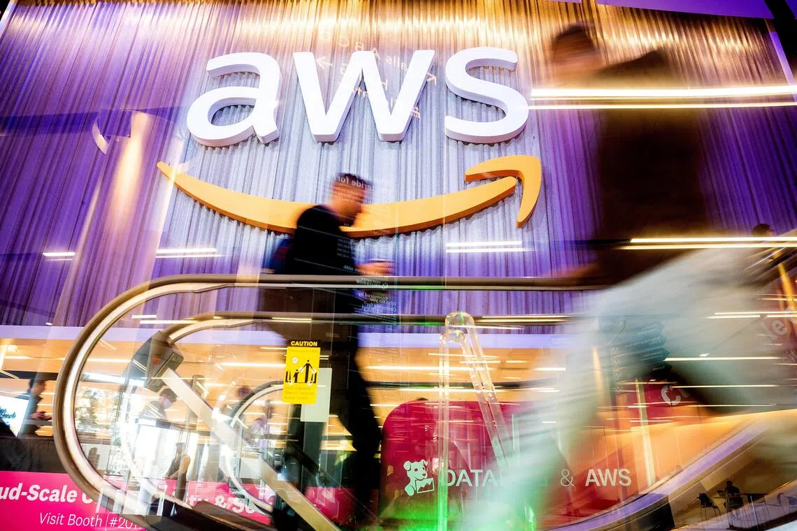 FILE PHOTO: Attendees walk through AWS re:Invent 2022, a conference hosted by Amazon Web Services (AWS), in Las Vegas, Nevada, U.S., November 30, 2022. Noah Berger/AWS/Handout via REUTERS THIS IMAGE HAS BEEN SUPPLIED BY A THIRD PARTY. MANDATORY CREDIT/File Photo