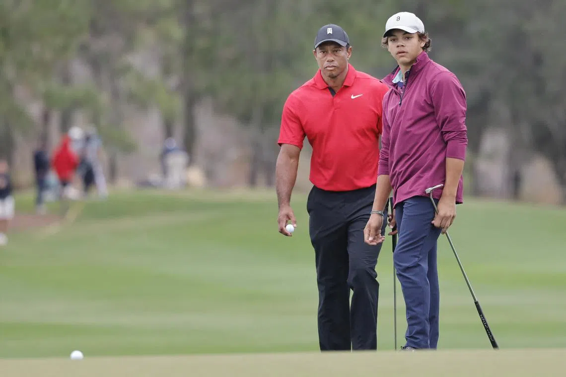 Dec 17, 2023; Orlando, Florida, USA;  Tiger Woods watches as his son Charlie Woods (right) putt rolls up to the cup during the PNC Championship at The Ritz-Carlton Golf Club. Reinhold Matay-USA TODAY Sports/File Photo