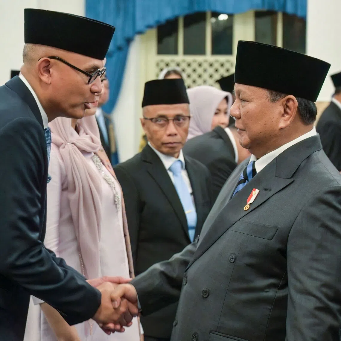 Indonesian President Prabowo Subianto (right) shakes hands with newly appointed Indonesian Minister of Foreign Affairs Arrmanatha Christiawan Nasir  during his inauguration ceremony at the State Palace in Jakarta on Oct 1.