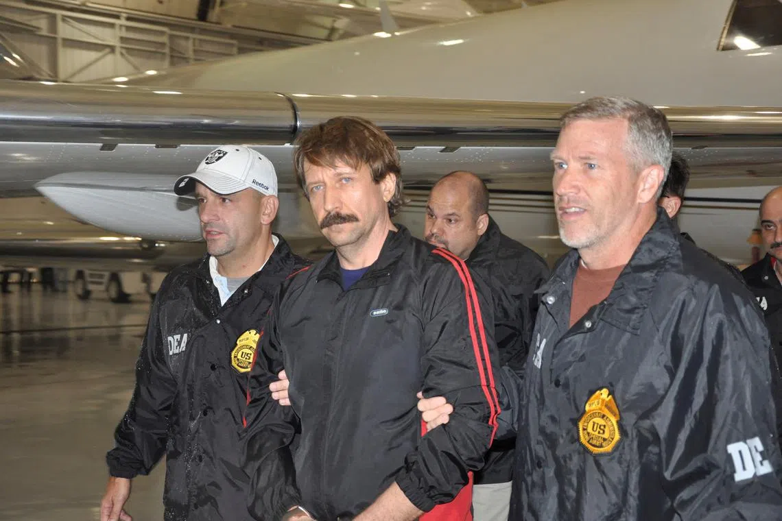 FILE PHOTO: Suspected Russian arms dealer Viktor Bout (C) is escorted by Drug Enforcement Administration (DEA) officers after arriving at Westchester County Airport in White Plains, New York November 16, 2010. REUTERS/U.S. Department of Justice/Handout/File Photo