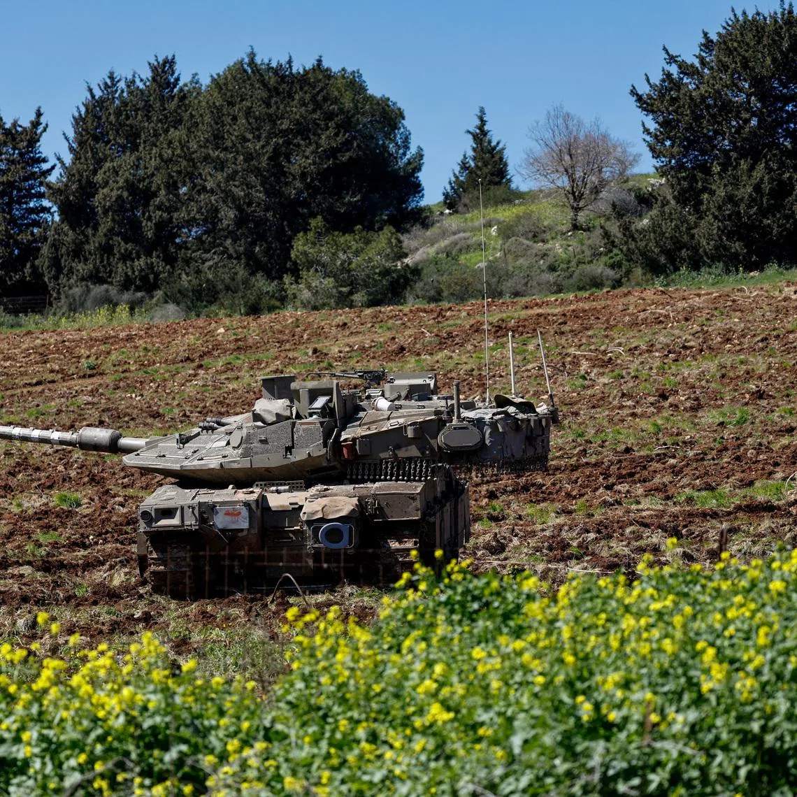 FILE PHOTO: Israeli tanks on the Israeli side of the Israel-Lebanon border, following an escalation between Hezbollah and Israel amid the U.S.-Israeli conflict with Iran, in northern Israel, March 8, 2026. REUTERS/Amir Cohen/File Photo