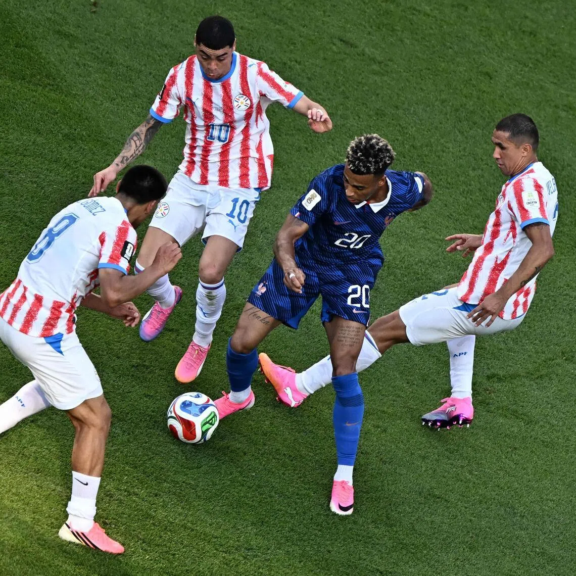 France’s Desire Doue weaving through a trio of Paraguay defenders, which ultimately led to him being tripped by Diego Gomez (left) and earning a penalty that striker Kylian Mbappe duly converted as Les Bleus won the World Cup last-16 clash 1-0.
