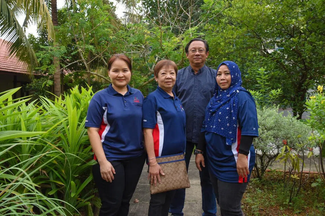Medical escorts (front row, from left) Nant Mu Sikalain (Freda), Teo Poh Choo and Maria Mohamed from Handicaps Welfare Association, with HWA senior manager Simon Ching.