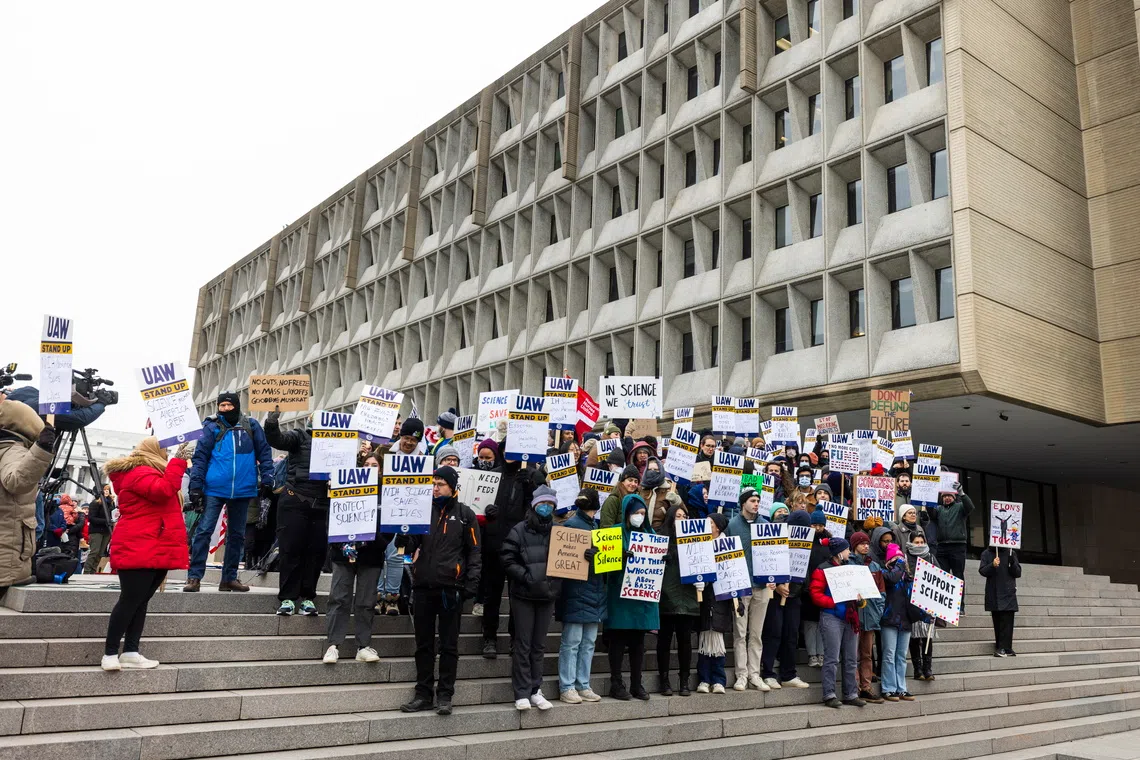 Researchers, academics and protesters rally outside the Health and Human Services Building against funding freezes on research and higher education in Washington, on Feb 19.