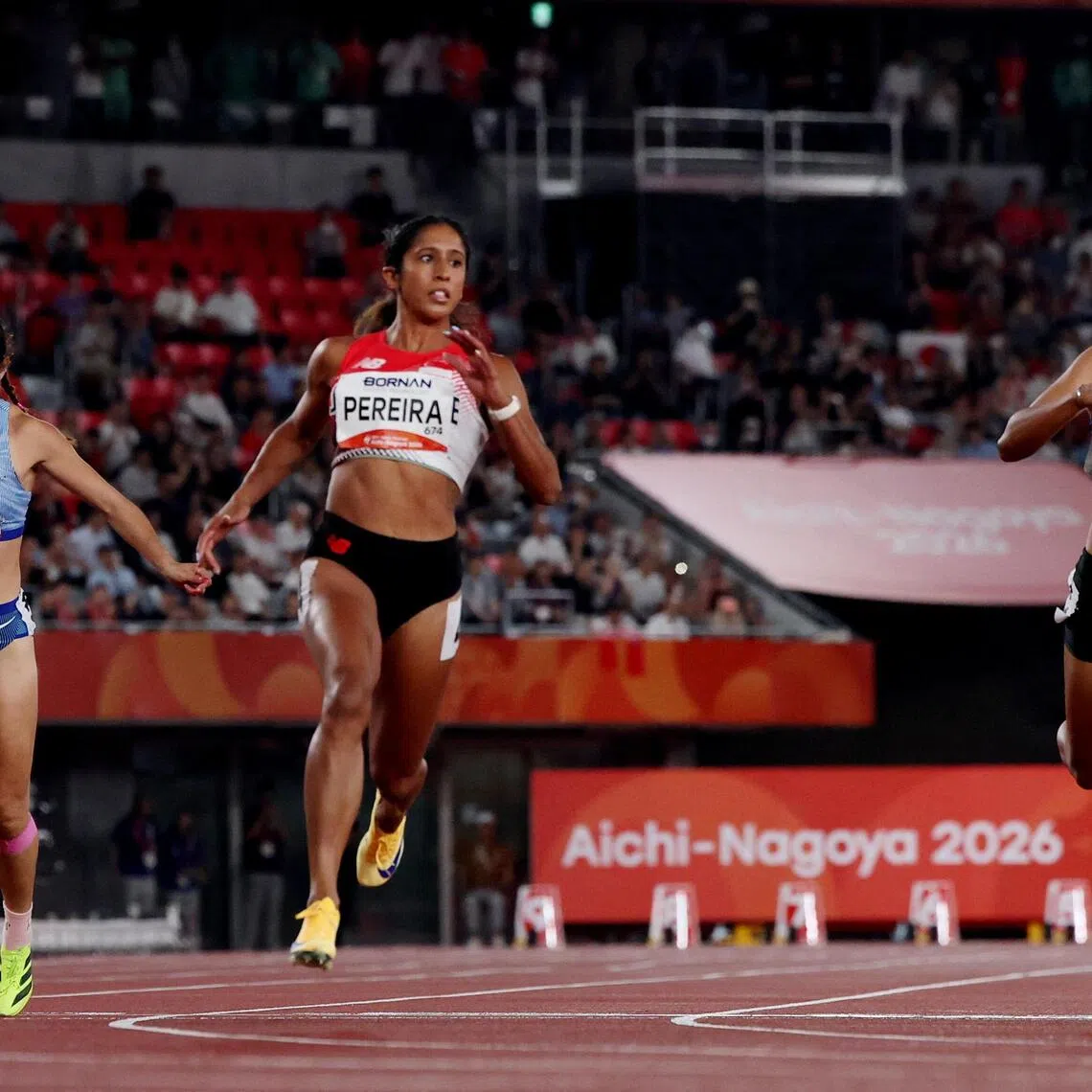 Asian Games - Aichi-Nagoya 2026 - Athletics - Paloma Mizuho Sports Park, Nagoya, Japan - September 25, 2026
Singapore's Shanti Pereira  in action with Taiwan's Yan-jun Liao and Thailand's Sukanda Petraksa during the Women's 100m Semi Final Heat 1 REUTERS/Chalinee Thirasupa