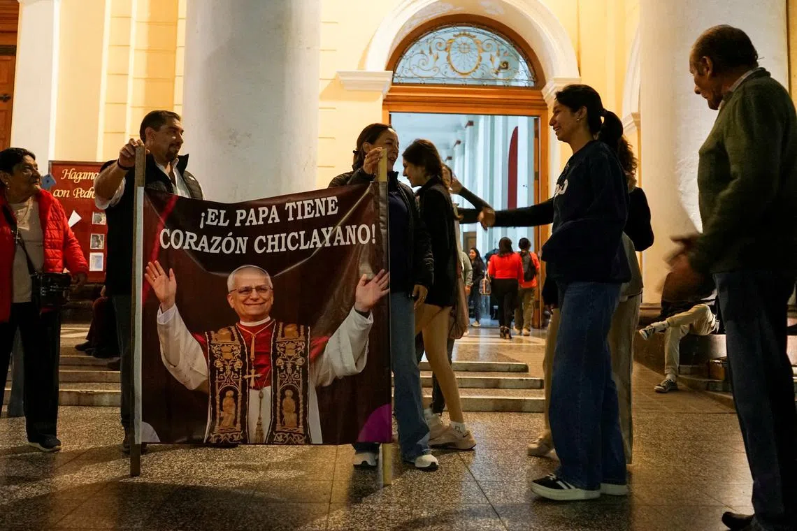 FILE PHOTO: People celebrate at the Cathedral of Saint Mary, on the day of the election of Pope Leo XIV, in Chiclayo, Peru May 8, 2025. REUTERS/Diego Torres Menchola/File Photo