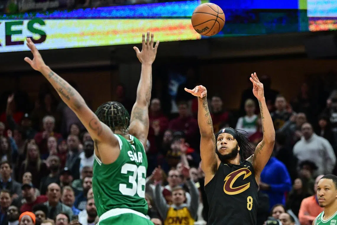 Cleveland Cavaliers forward Lamar Stevens shoots over Boston Celtics guard Marcus Smart during overtime at Rocket Mortgage FieldHouse.