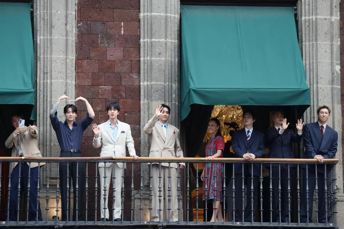 Mexico's President Claudia Sheinbaum and members of South Korean Kpop boy band BTS react as they stand on a balcony of the National Palace ahead of a series of concerts on the BTS World Tour "Arirang" in Mexico City, Mexico, May 6, 2026. REUTERS/Luis Cortes