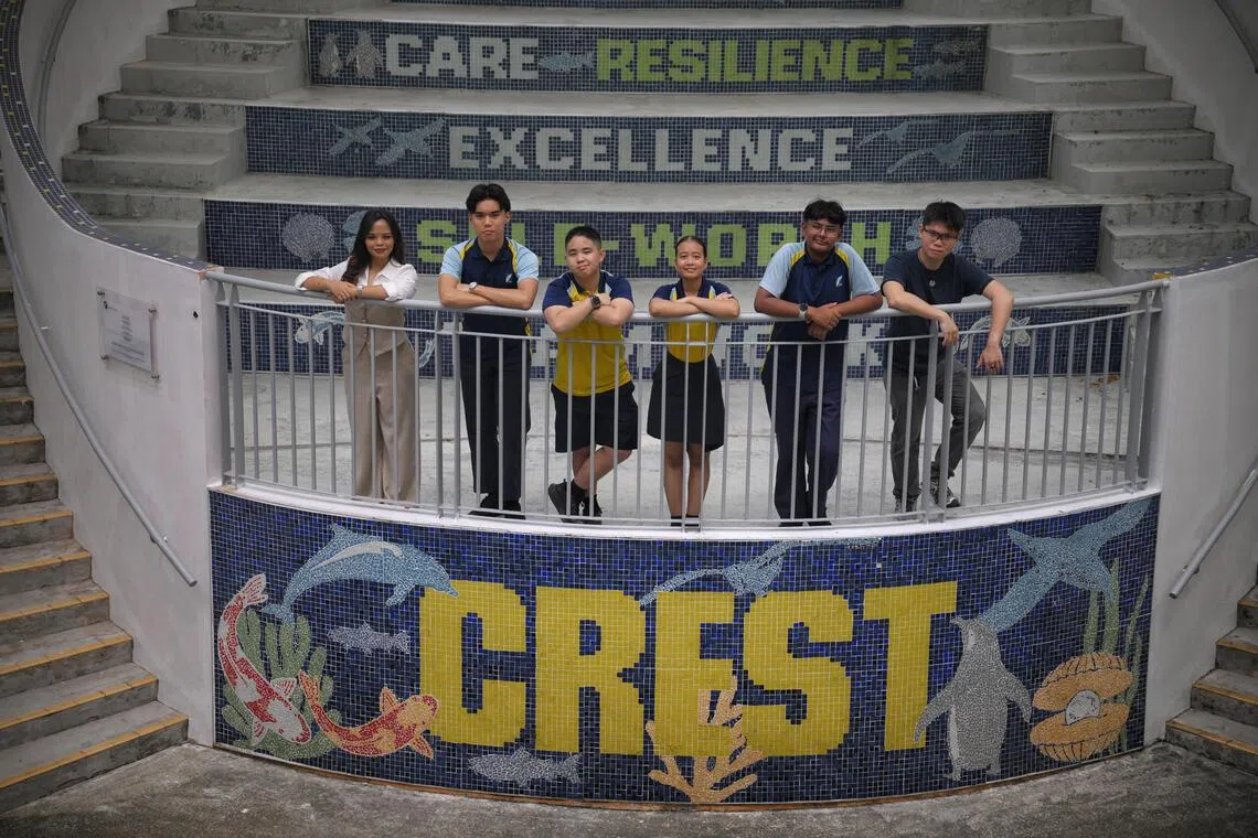 Crest Secondary School Alumnus Nur Saminah Sabtu (far left), 26 and Eric Liang (far right), 25, with current students, from left, Asher Cheow, 16, Willy Ng, 14, Ellefirah Ellyza Muhammad Firdaus, 16, and Muhammed Gaazi Basheer Ahmad, 15, pictured at the school's campus on Oct 12.