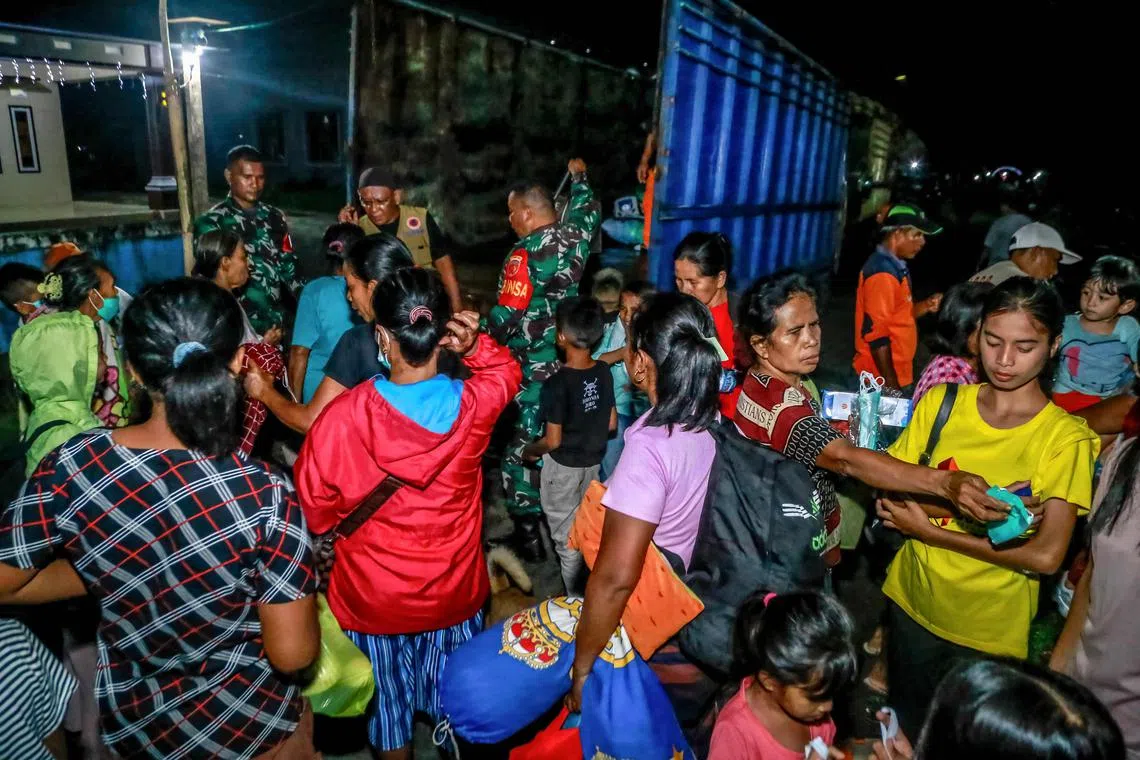 Evacuees rush to leave Sangaji Nyeku Village following the eruption of Mount Ibu.