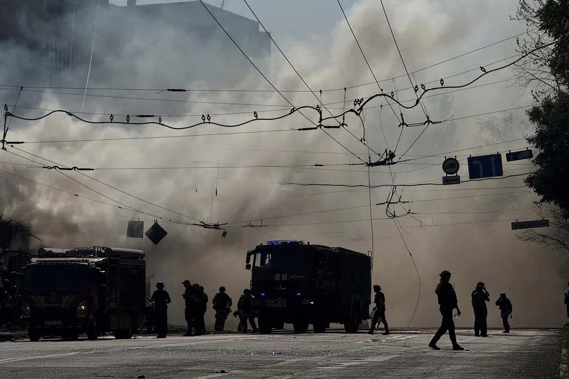 Firefighters working at the site of a Russian missile strike, amid Russia's attack on Ukraine, in Zaporizhzhia, Ukraine, Aug 18, 2025. 