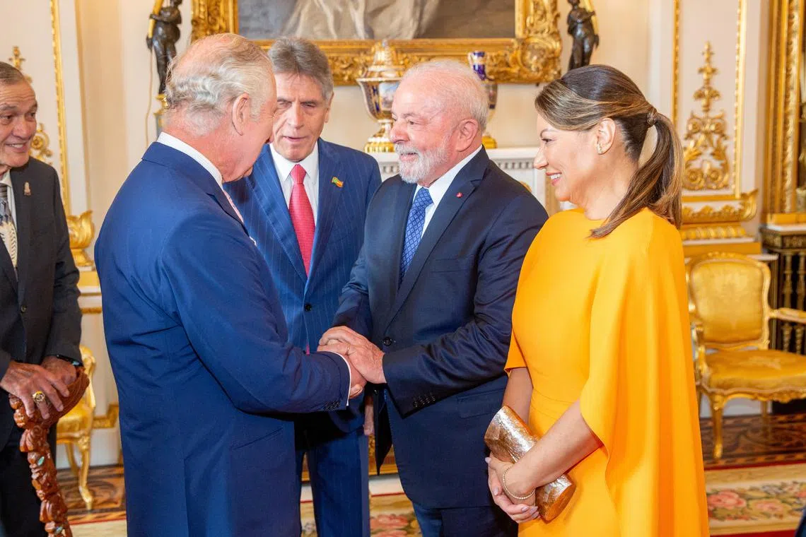 Britain's King Charles greets Brazil's President Luiz Inacio Lula da Silva and his wife first lady Rosangela da Silva on May 5, 2023.