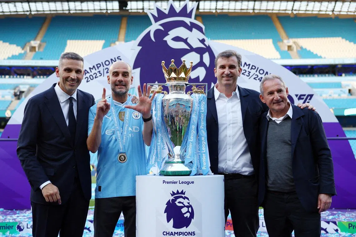 Manchester City manager Pep Guardiola, chairman Khaldoon Al Mubarak, chief executive Ferran Soriano and director of football Txiki Begiristain celebrate with the trophy after winning the Premier League.