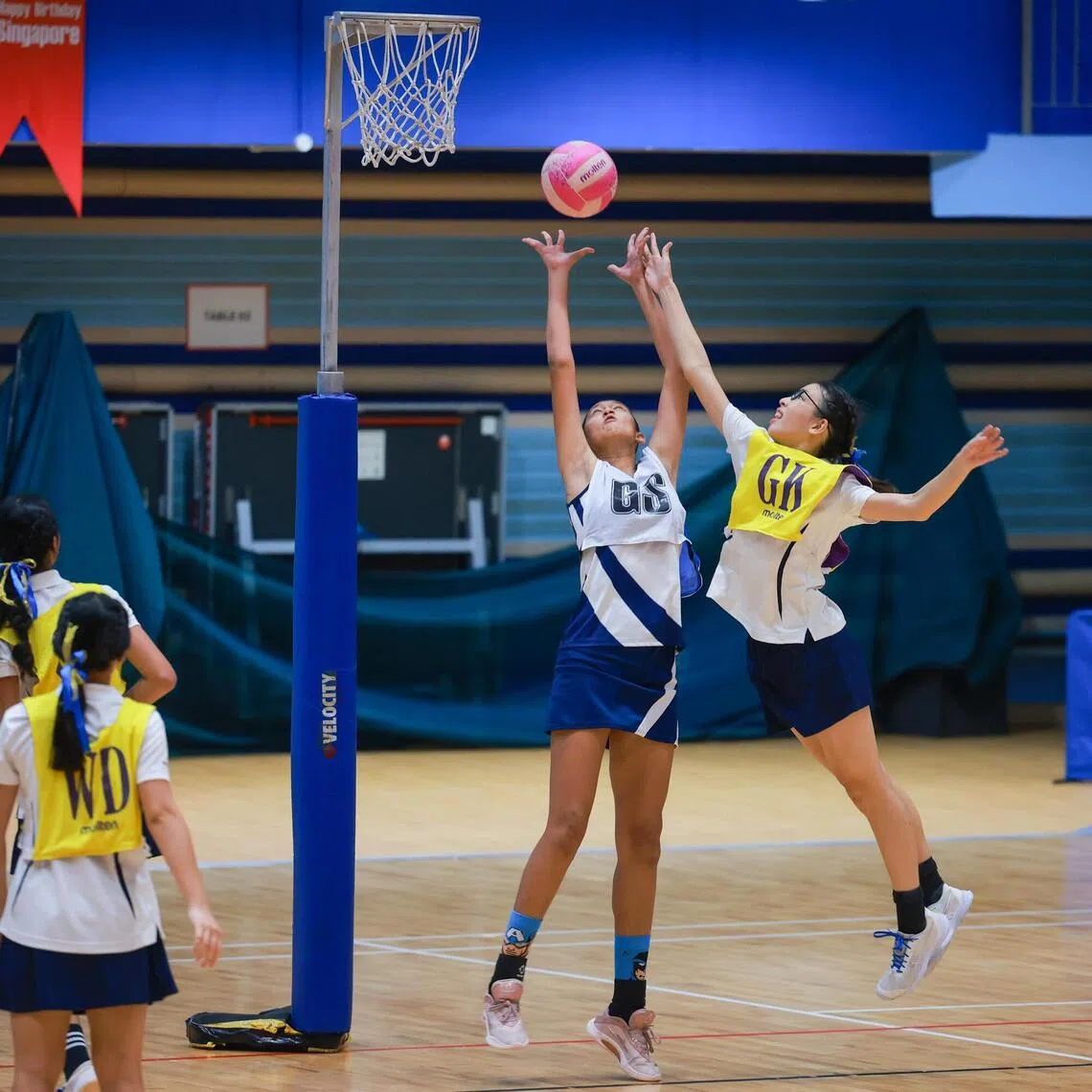 CHIJ Secondary (Toa Payoh)’s 1.9m-tall Naomi Pathman (middle) towered over Methodist Girls’ School’s Chloe Ma (right) in the C Division Netball final at Jurong East Sports Hall.