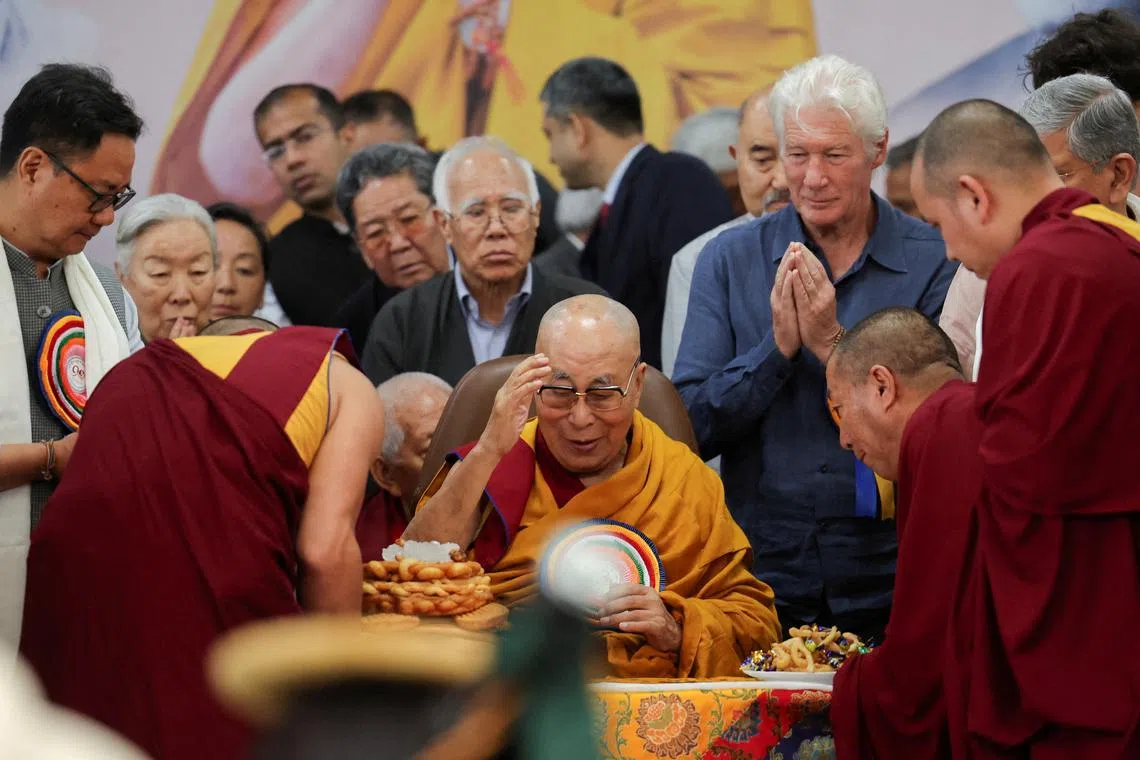 FILE PHOTO: Tibetan spiritual leader, the 14th Dalai Lama, is served food on his 90th birthday celebration at the Tsuglagkhang, also known as the Dalai Lama Temple complex, in the northern town of Dharamshala, India, July 6, 2025. REUTERS/Anushree Fadnavis/File Photo