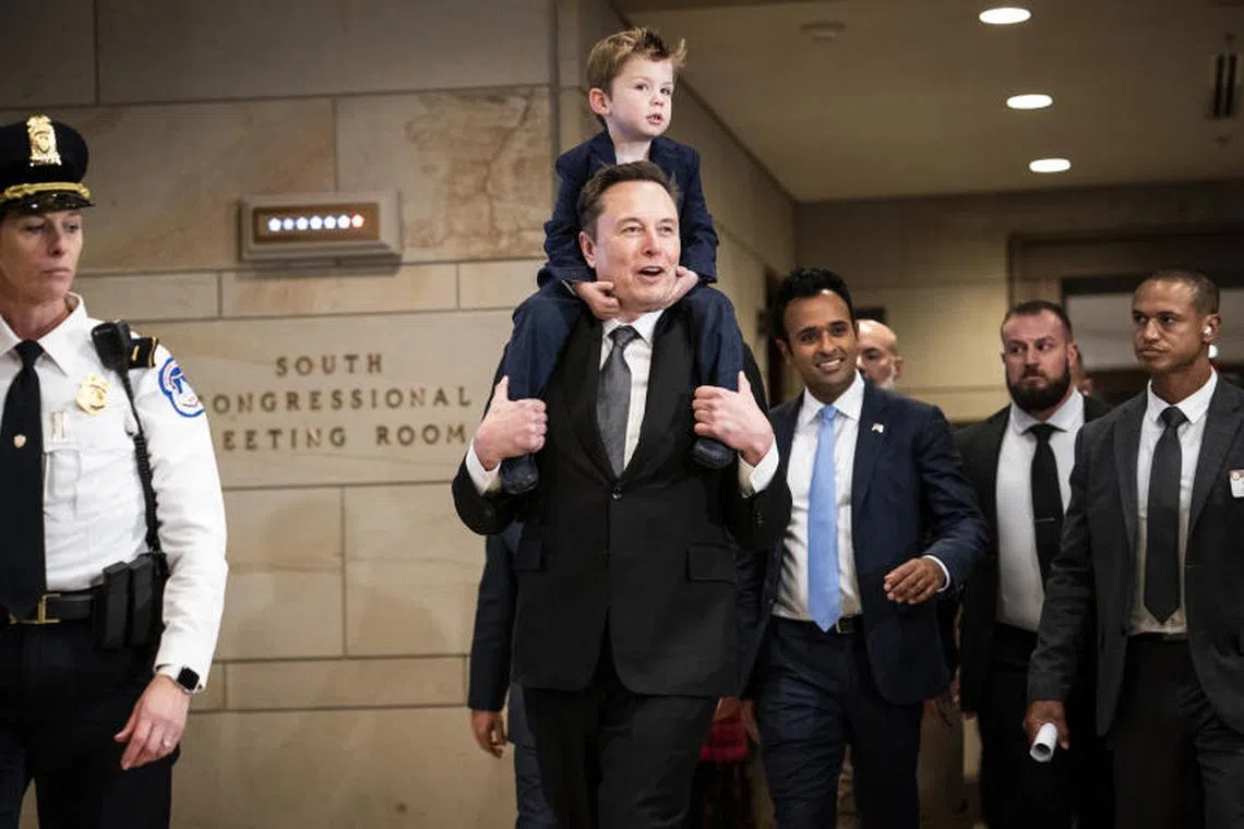 FILE Ñ Elon Musk, with his son X ® A-Xii Musk, walks with Vivek Ramaswamy on Capitol Hill on Thursday, Dec. 5, 2024. TrumpÕs so-called Department of Government Efficiency has been on a hiring spree, looking for tech executives and conservative activists to dig into the federal government and look for rules and spending to cut. (Haiyun Jiang/The New York Times)
