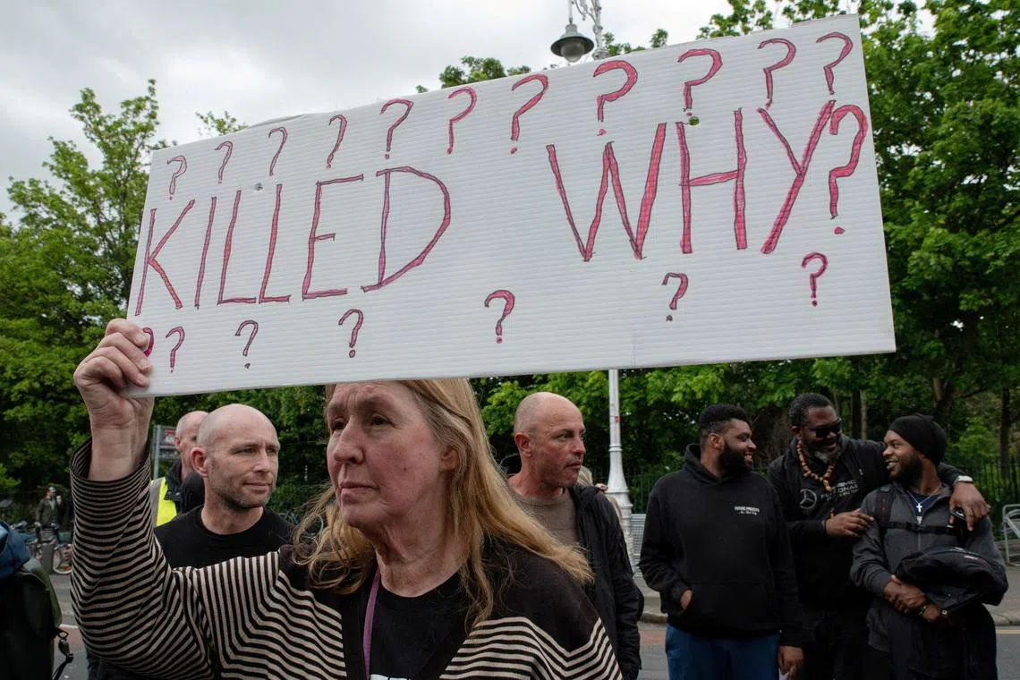 People hold placards during a protest following the death of Yves Sakila, a Congolese-born man who died after being restrained by security guards outside a department store, outside Leinster House in Dublin, Ireland, May 21, 2026. REUTERS/Natalia Campos
