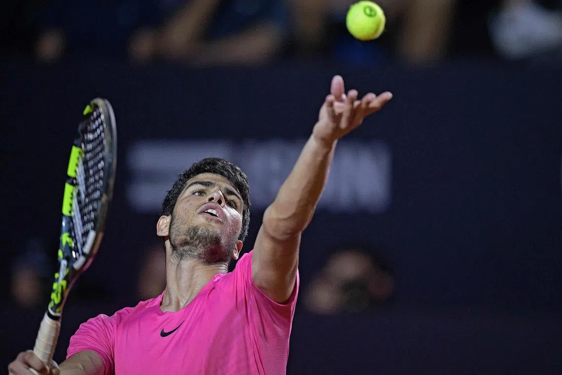 Spaniard Carlos Alcaraz serving to Italian Fabio Fognini en route to a 6-7 (5-7), 6-2, 6-4 victory at the Rio Open.