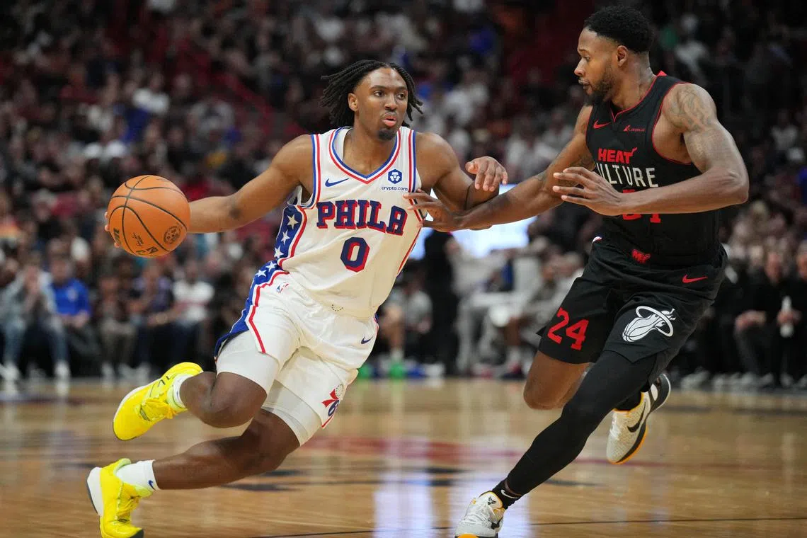Philadelphia 76ers guard Tyrese Maxey driving past Miami Heat forward Haywood Highsmith during the second half of the Sixers' 109-105 NBA victory at Kaseya Centre on April 4.