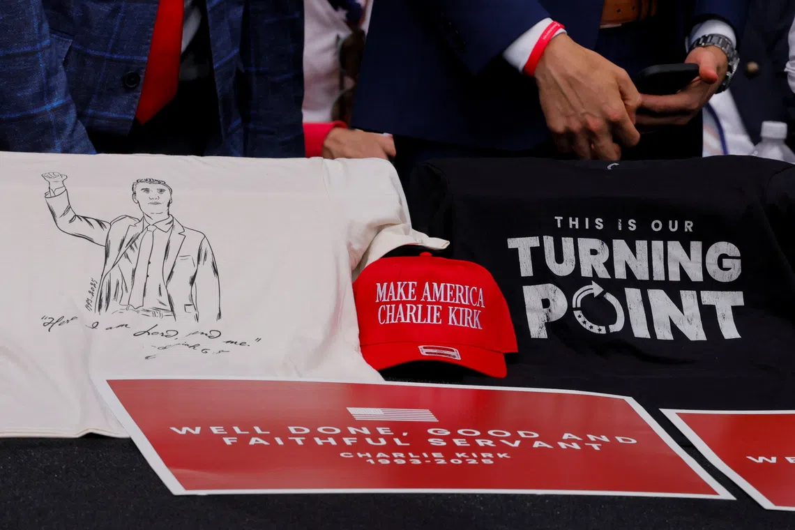 A  hat reading "Make America Charlie Kirk" and placards sit next to a T-shirt with an image depicting slain conservative commentator Charlie Kirk during a memorial service at State Farm Stadium, in Glendale, Arizona, U.S., September 21, 2025.  REUTERS/Brian Snyder
