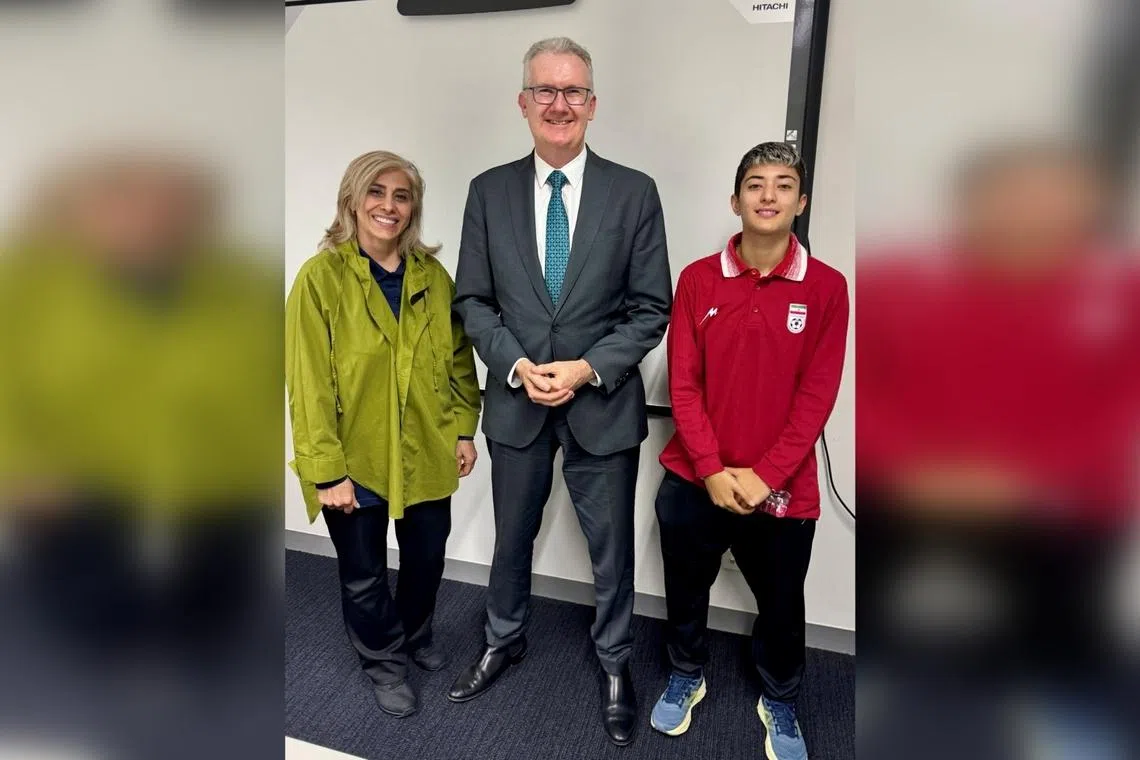 Australia's Home Affairs Minister Tony Burke poses with Iranian women's soccer team support worker Zahra Soltan Meshkeh Kar and team player Mohaddeseh Zolfi, who were granted asylum overnight, in Australia, on March 10.