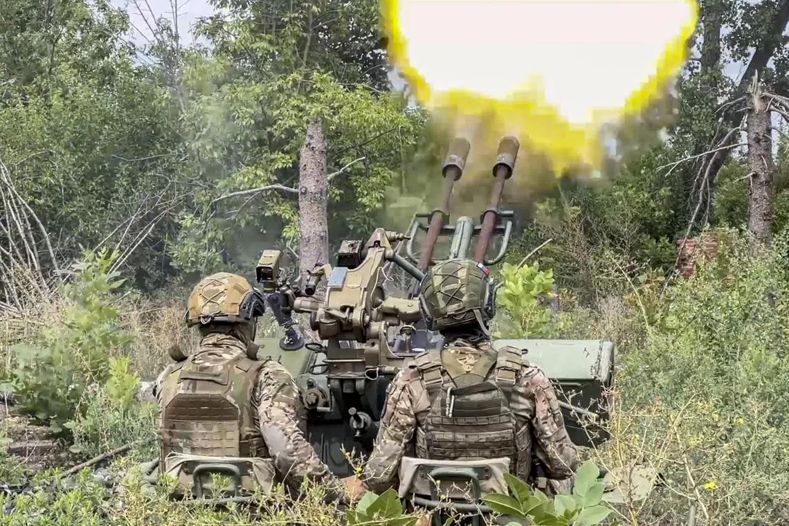 A Russian air defence crew use a 23mm anti-aircraft gun to shoot down Ukrainian attack drones.