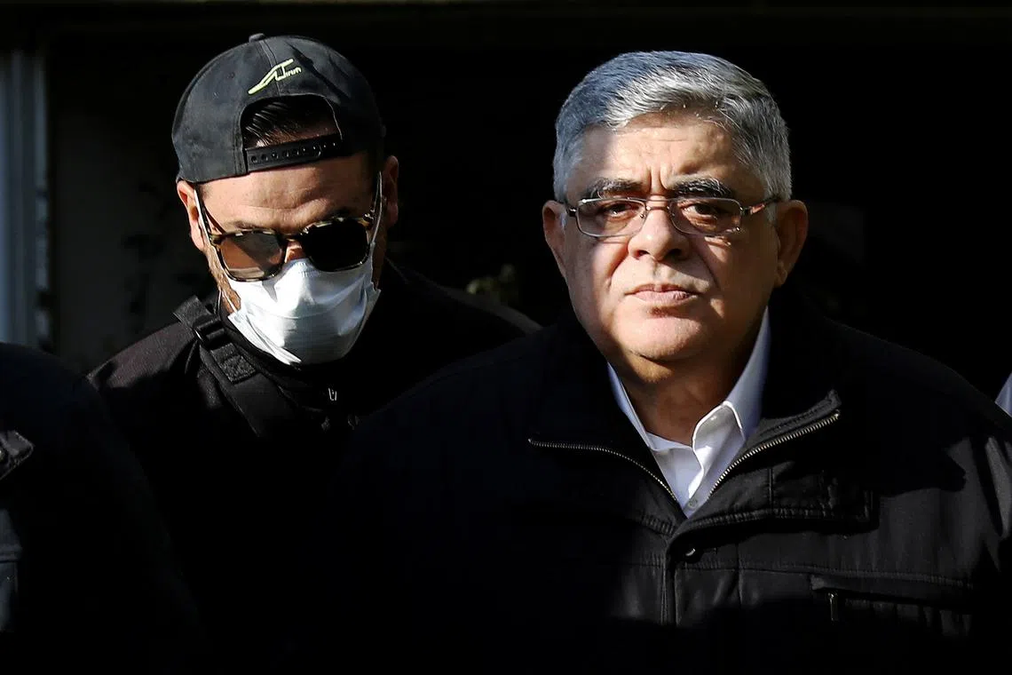 Leader of the far-right Golden Dawn party Nikos Mihaloliakos is escorted as he leaves his home, after the party was declared a criminal organisation by a court in Athens, Greece, October 22, 2020. REUTERS/Costas Baltas/ File Photo
