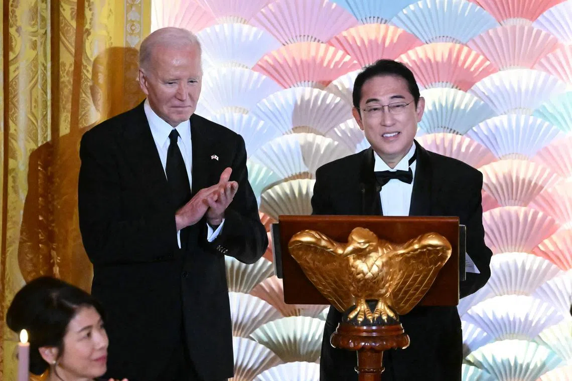 US President Joe Biden applauds as Japanese Prime Minister Fumio Kishida speaks during a State Dinner in the White House in Washington, DC. 