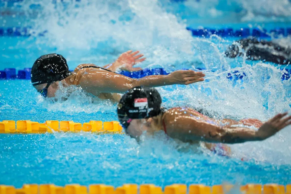 (From left) Siblings Quah Ting Wen and Quah Jing Wen competing in the women’s 100m butterfly final at the Huamark Aquatic Center in Bangkok on Dec 13. Ting Wen edged her younger sister by just 0.01 of a second to take the gold.