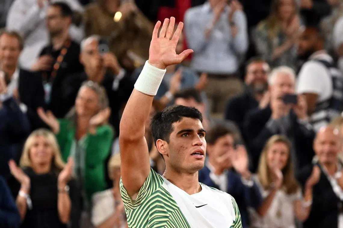 Spain's Carlos Alcaraz celebrates winning against Greece's Stefanos Tsitsipas.