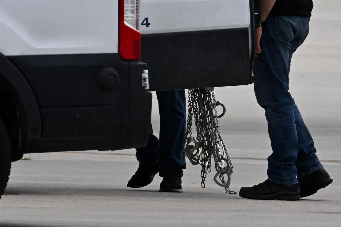 FILE PHOTO: Handcuffs are carried after being removed from detained migrants who boarded a plane after being transferred from an ICE detention facility, at Gary/Chicago International Airport, in Gary, Indiana, U.S., June 20, 2025. REUTERS/Dylan Martinez/File photo